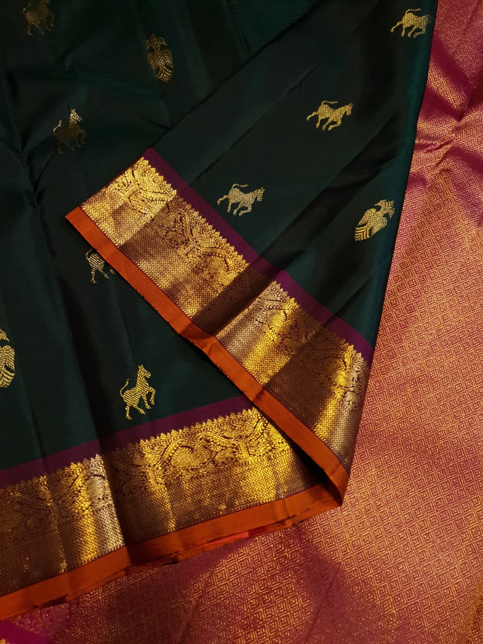 Bottle Green Kanjivaram Silk Saree with  Pink Zari Border.